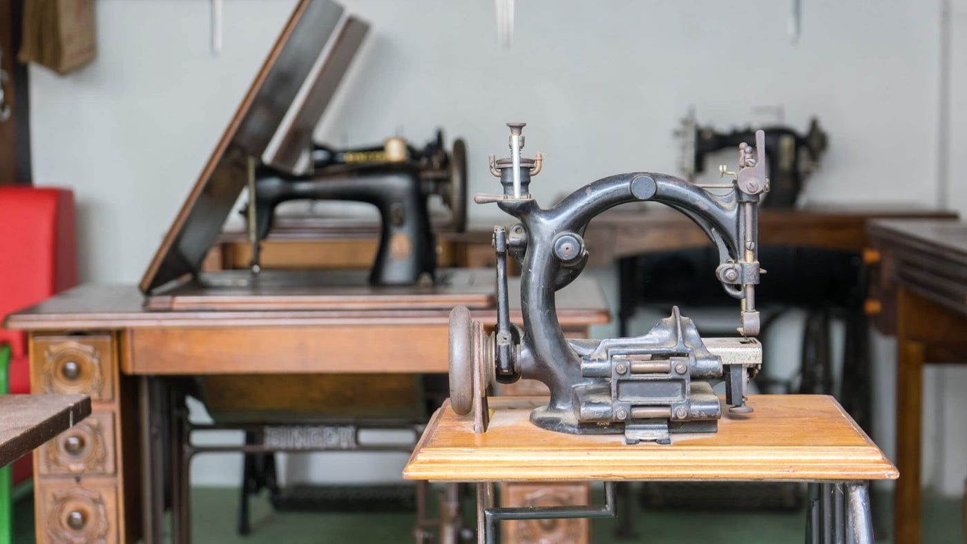 Vintage sewing machine on a wooden table with a blurred background